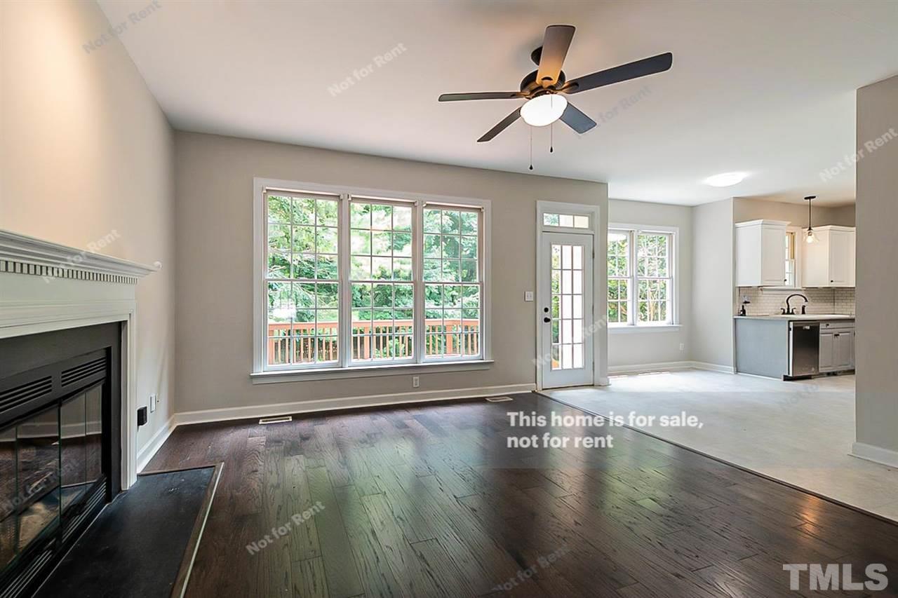 8528 Yucca Trail Raleigh, NC 27615 - Photo 10 of 21 a view of an empty room with window and wooden floor