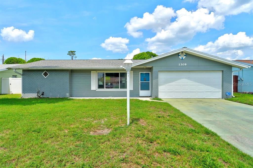 1309 Suwanee Road Daytona Beach, FL 32114 - Photo 1 of 33 a front view of a house with a yard