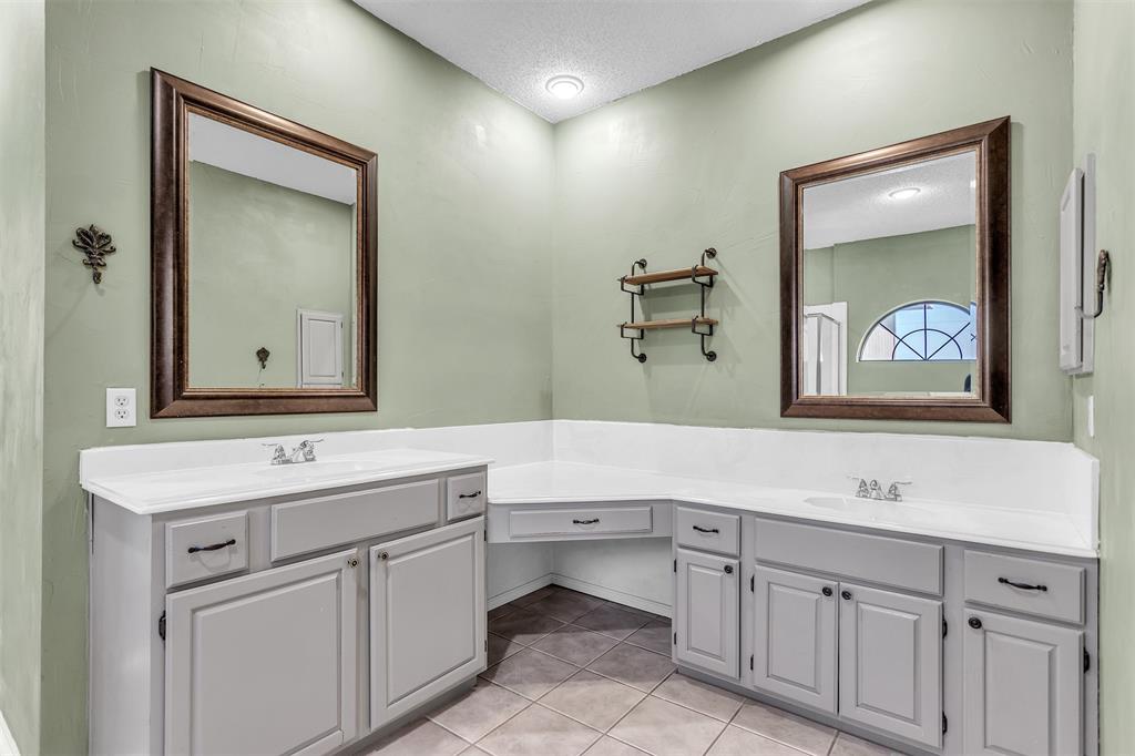 6613 Springmeadow Lane Rowlett, TX 75089 - Photo 13 of 20 a bathroom with a sink and a mirror