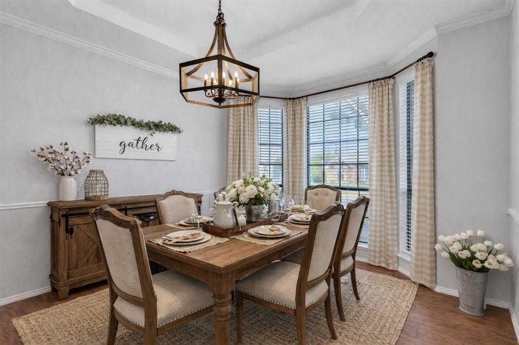 6613 Springmeadow Lane Rowlett, TX 75089 - Photo 14 of 20 a view of a dining room with furniture wooden floor and chandelier