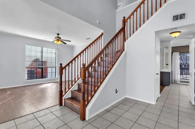 a view of an entryway wooden floor and chandelier