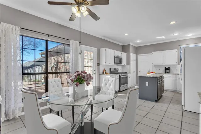 a kitchen with stainless steel appliances kitchen island granite countertop a refrigerator a stove a sink dishwasher with a dining table and chairs