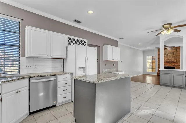 a kitchen with stainless steel appliances granite countertop a sink and cabinets