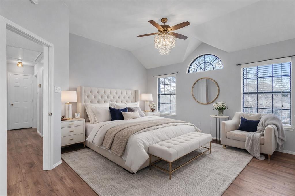 6613 Springmeadow Lane Rowlett, TX 75089 - Photo 10 of 20 a bedroom with a large bed and a chandelier