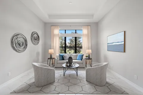a living room with furniture kitchen view and a window