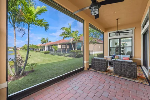 a front view of a house with a yard and potted plants