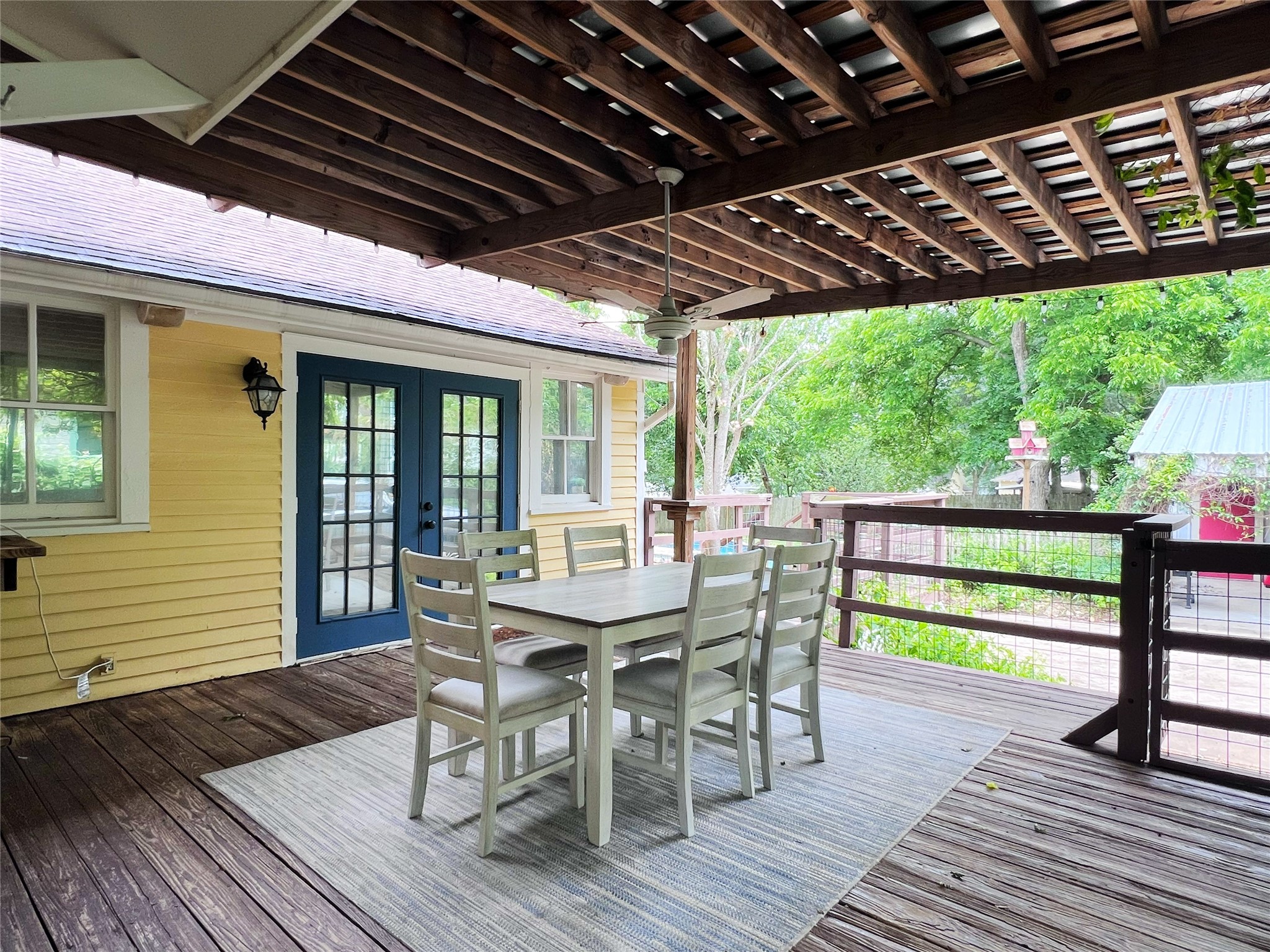 606 Sycamore Street Brenham, TX 77833 - Photo 21 of 27 a view of a patio with a table chairs and wooden floor