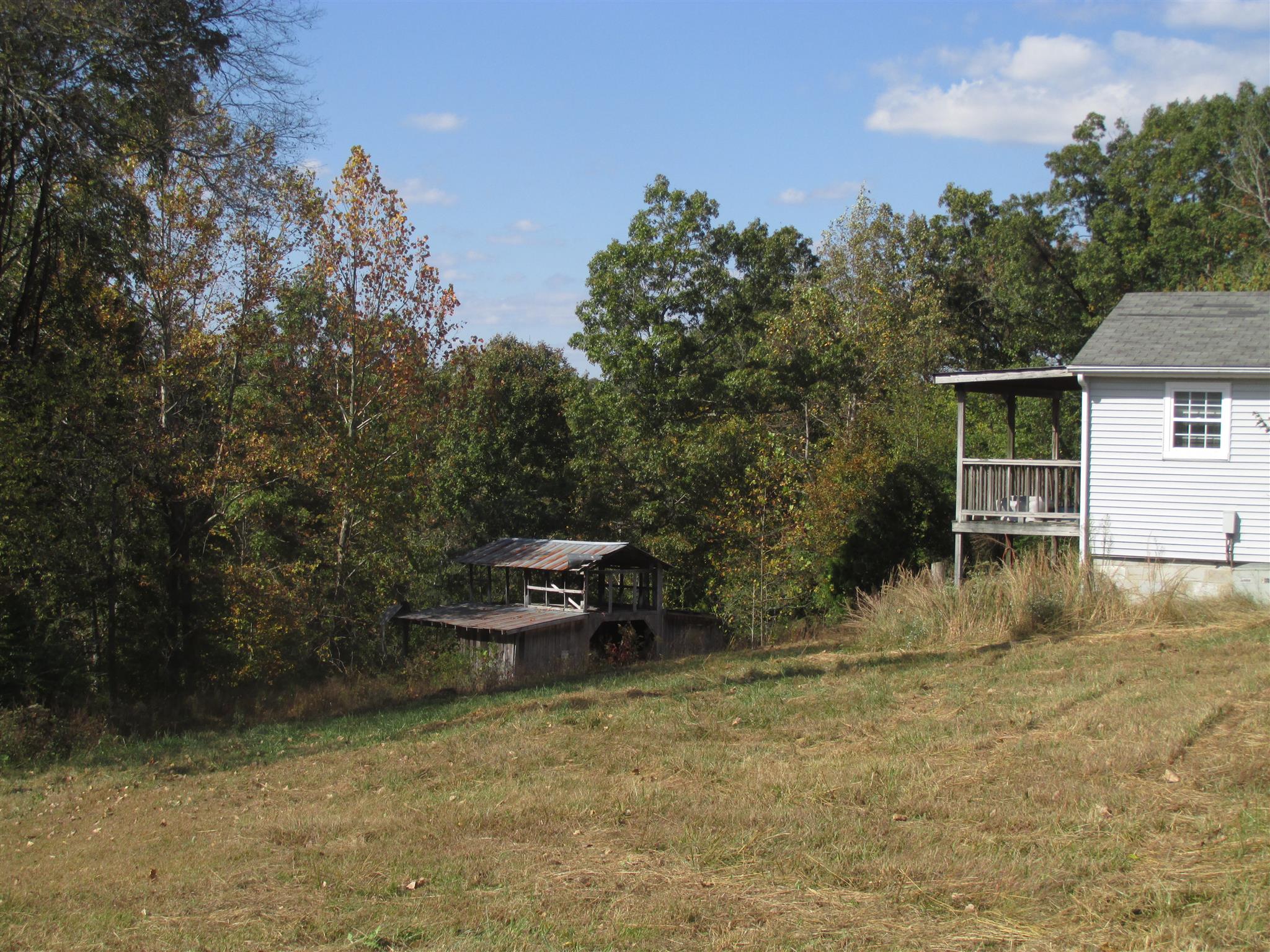 997 Pack Road White Bluff, TN 37187 - Photo 2 of 11 a view of a backyard with table and chairs and potted plants