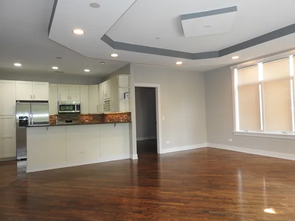 a view of kitchen with stainless steel appliances refrigerator sink and cabinets