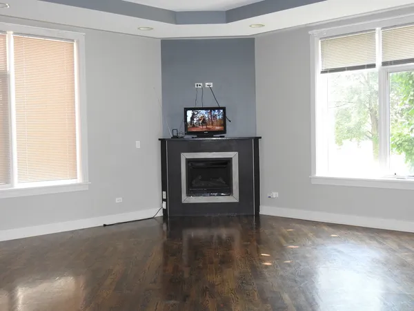 a living room with a fireplace and a window