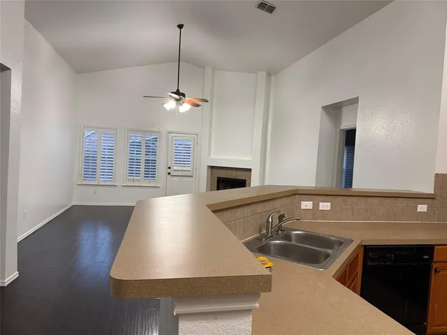 a view of backyard with wooden fence