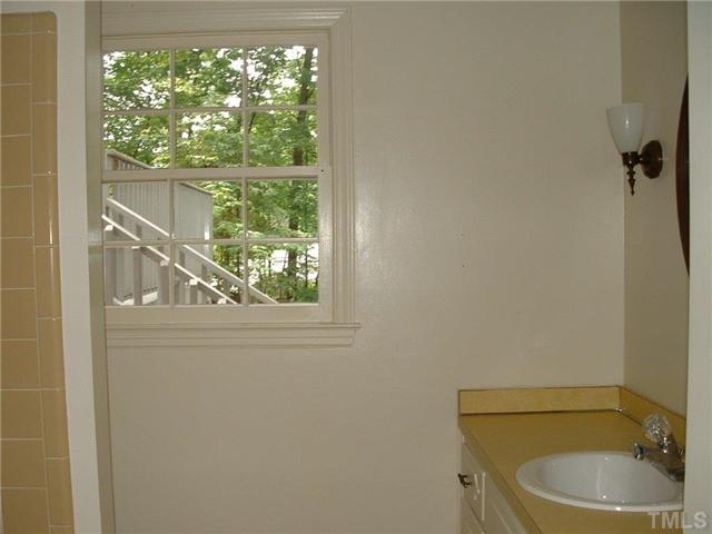 2717 Wycliff Road Raleigh, NC 27607 - Photo 8 of 9 a bathroom with a toilet a sink and window