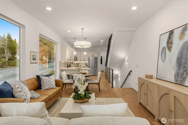 a living room with furniture fireplace and a large window