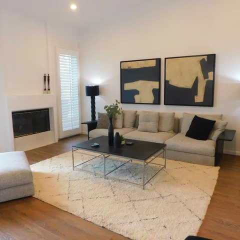 a view of a workspace with furniture and a painting on the wall