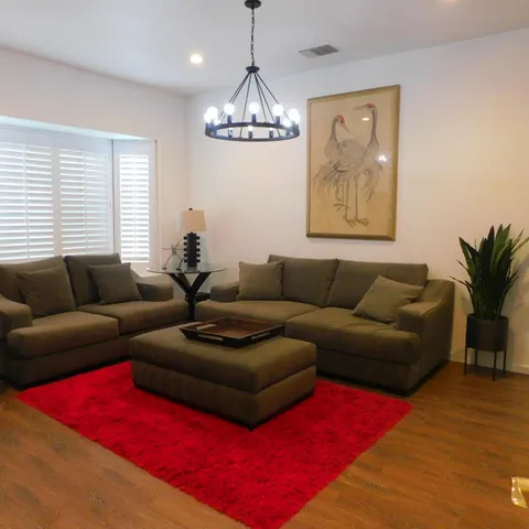 a blue bed in a bedroom next to a window