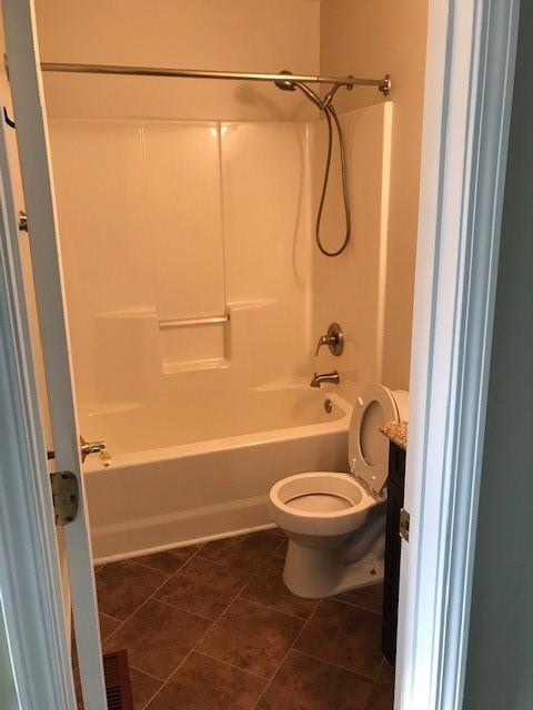 4086 Parks Road Flowery Branch, GA 30542 - Photo 13 of 23 a bathroom with a granite countertop bathtub shower sink vanity and toilet