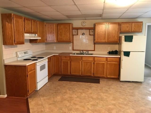 4086 Parks Road Flowery Branch, GA 30542 - Photo 15 of 23 a kitchen with stainless steel appliances granite countertop a stove sink and cabinets