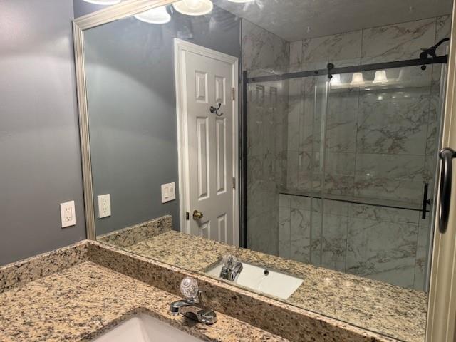 4086 Parks Road Flowery Branch, GA 30542 - Photo 8 of 23 a bathroom with a granite countertop sink a shower and a mirror