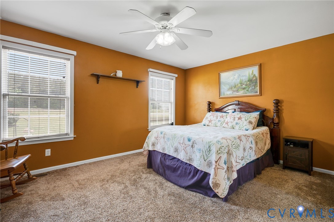 5280 West Quaker Road Disputanta, VA 23875 - Photo 28 of 33 a spacious bedroom with a bed and a window
