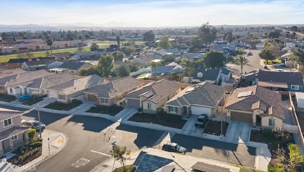an aerial view of residential houses with city view
