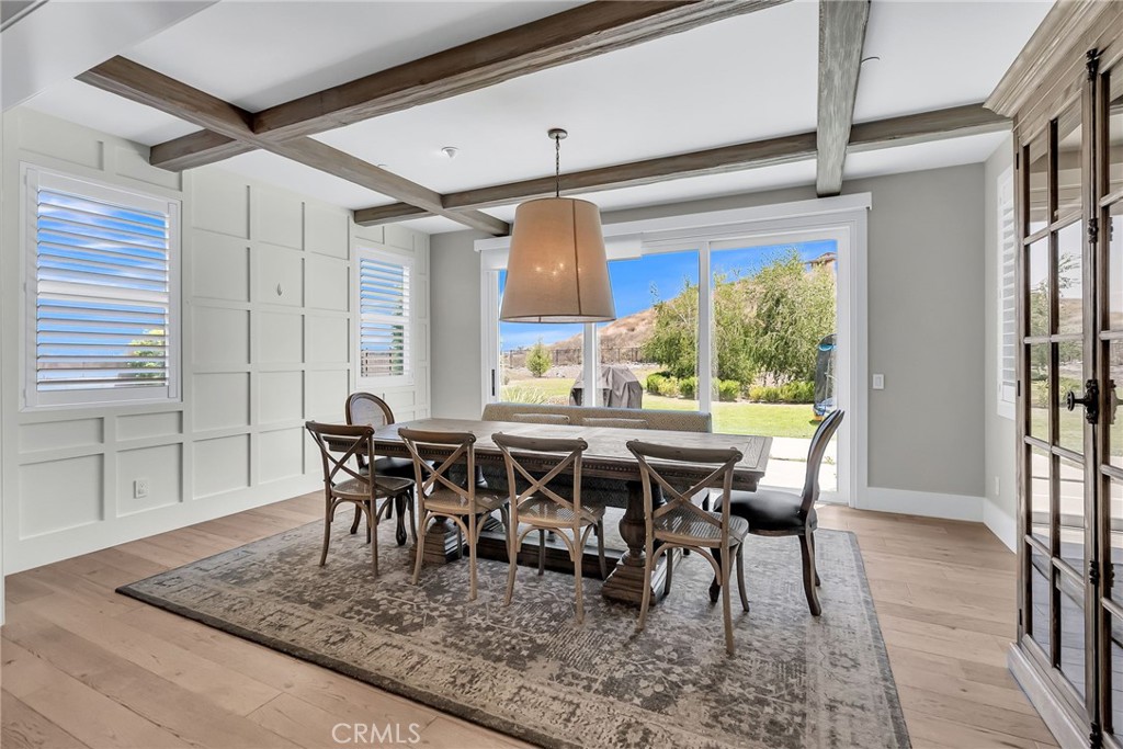 12237 Cortona Place Riverside, CA 92503 - Photo 15 of 60 a view of a dining room with furniture window and wooden floor