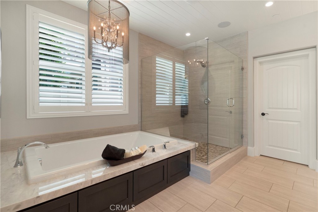 12237 Cortona Place Riverside, CA 92503 - Photo 25 of 60 a bathroom with a tub sink and mirror