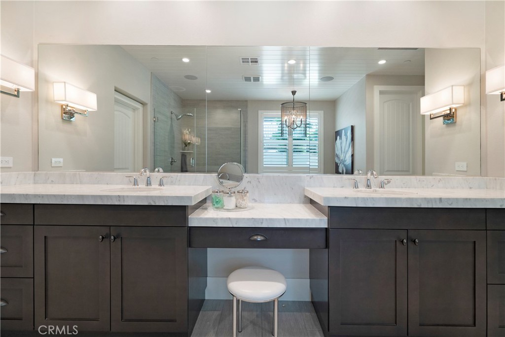 12237 Cortona Place Riverside, CA 92503 - Photo 26 of 60 a bathroom with a double vanity sink and a toilet