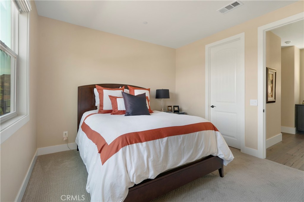 12237 Cortona Place Riverside, CA 92503 - Photo 29 of 60 a bedroom with a bed and window