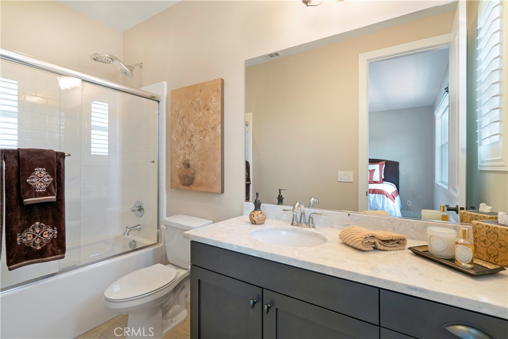 12237 Cortona Place Riverside, CA 92503 - Photo 30 of 60 a bathroom with a granite countertop sink toilet and shower