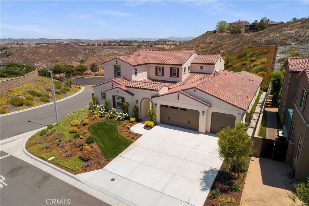 12237 Cortona Place Riverside, CA 92503 - Photo 34 of 60 an aerial view of a house with a garden and lake view