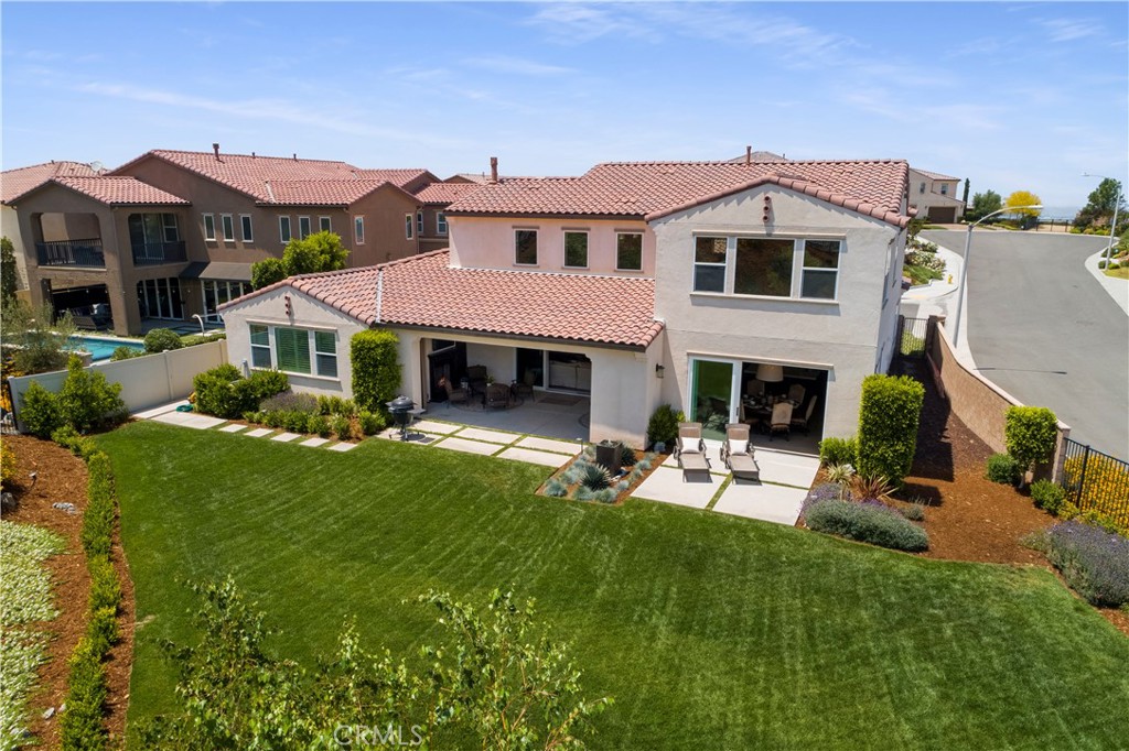 12237 Cortona Place Riverside, CA 92503 - Photo 36 of 60 a view of a yard with table and chairs under an umbrella