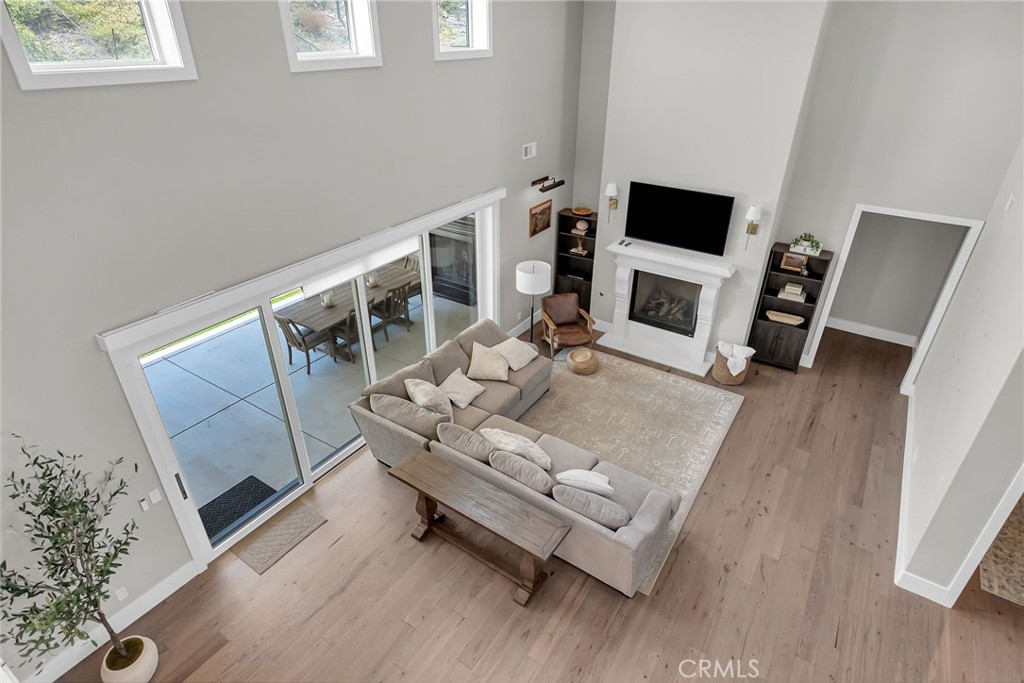 12237 Cortona Place Riverside, CA 92503 - Photo 4 of 60 a living room with furniture a fireplace and a flat screen tv