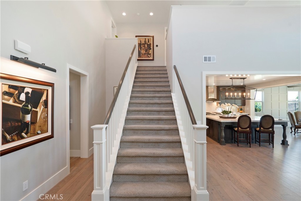 12237 Cortona Place Riverside, CA 92503 - Photo 42 of 60 a view of a hallway with wooden floor staircase and living room