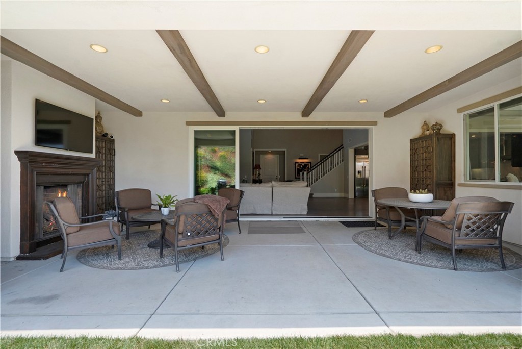 12237 Cortona Place Riverside, CA 92503 - Photo 48 of 60 a living room with furniture a flat screen tv and a fireplace