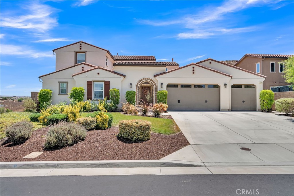 12237 Cortona Place Riverside, CA 92503 - Photo 5 of 60 a front view of a house with garden