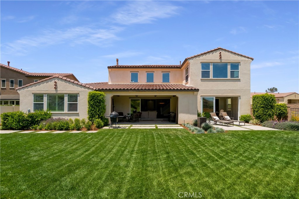 12237 Cortona Place Riverside, CA 92503 - Photo 53 of 60 a front view of a house with a yard and porch