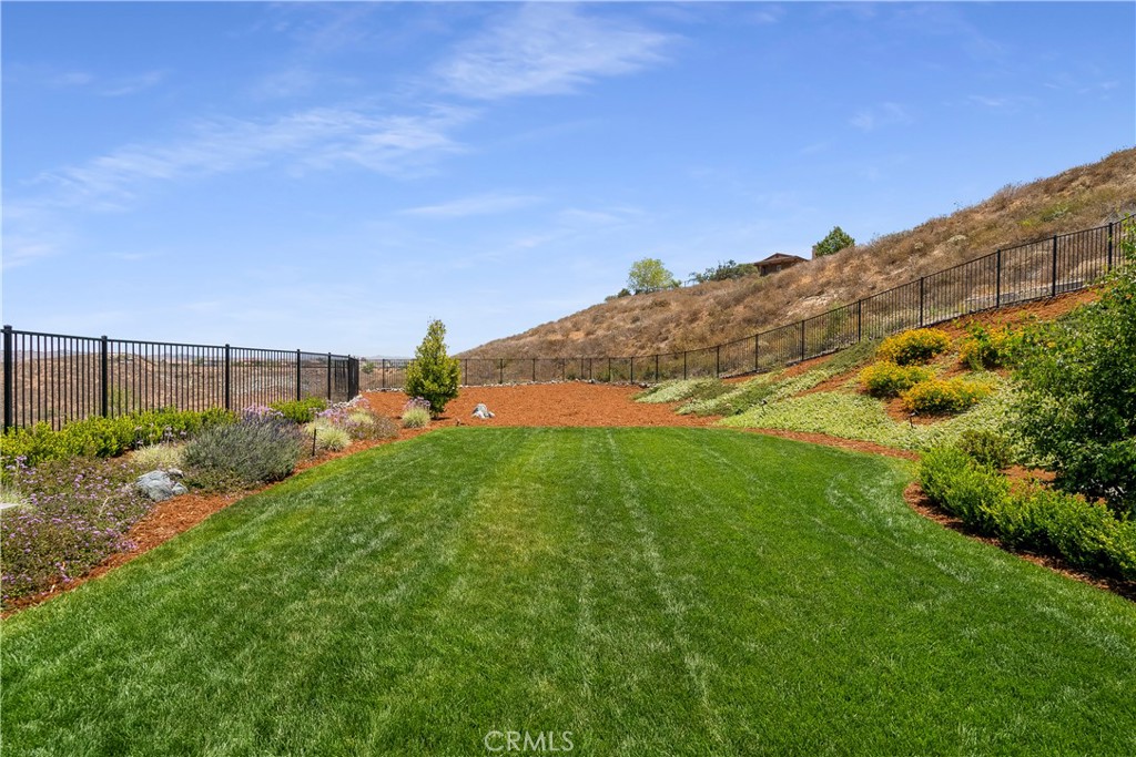 12237 Cortona Place Riverside, CA 92503 - Photo 58 of 60 a backyard of a house with lots of green space and mountain view in back
