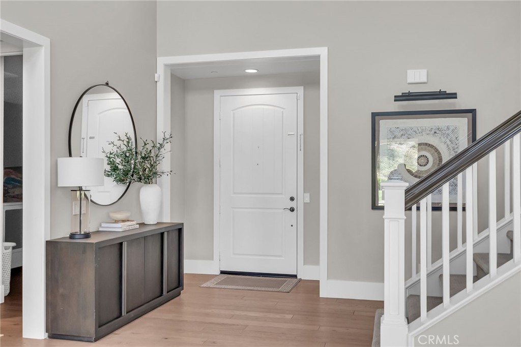 12237 Cortona Place Riverside, CA 92503 - Photo 9 of 60 a view of a hallway with entryway wooden floor and front door