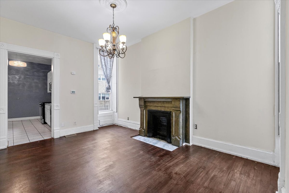 229 South Racine Avenue, Unit 1 Chicago, IL 60607 - Photo 5 of 10 a view of an empty room with wooden floor and a window