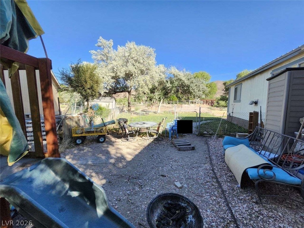 942 Holt Caliente, NV 89008 - Photo 2 of 22 A fenced backyard offers ample space for outdoor activities and storage solutions.