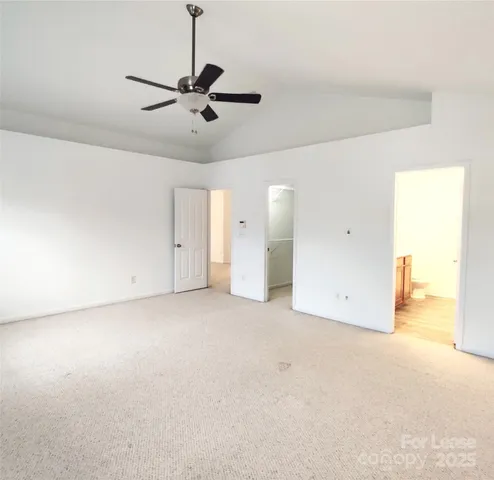 an empty room with closet and windows