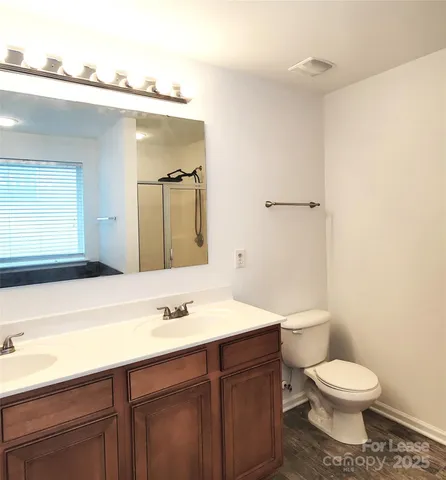 a bathroom with a sink a toilet and mirror