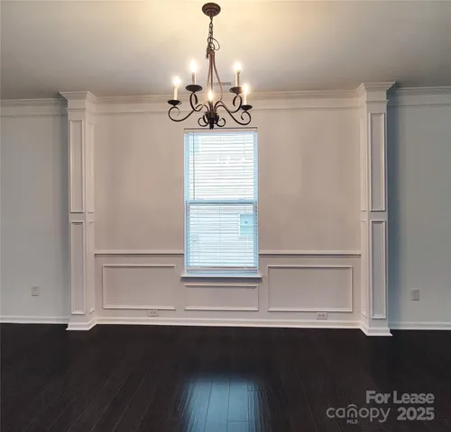 a view of a kitchen with a sink and wooden floor