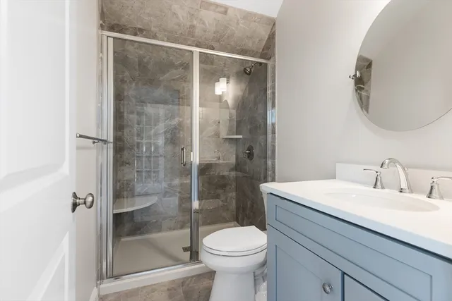 a bathroom with a sink toilet and shower