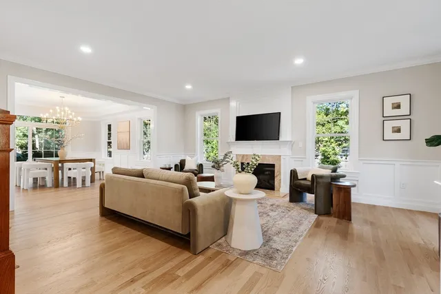 a living room with furniture a fireplace and a flat screen tv
