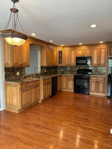a kitchen with stainless steel appliances granite countertop a stove and a sink