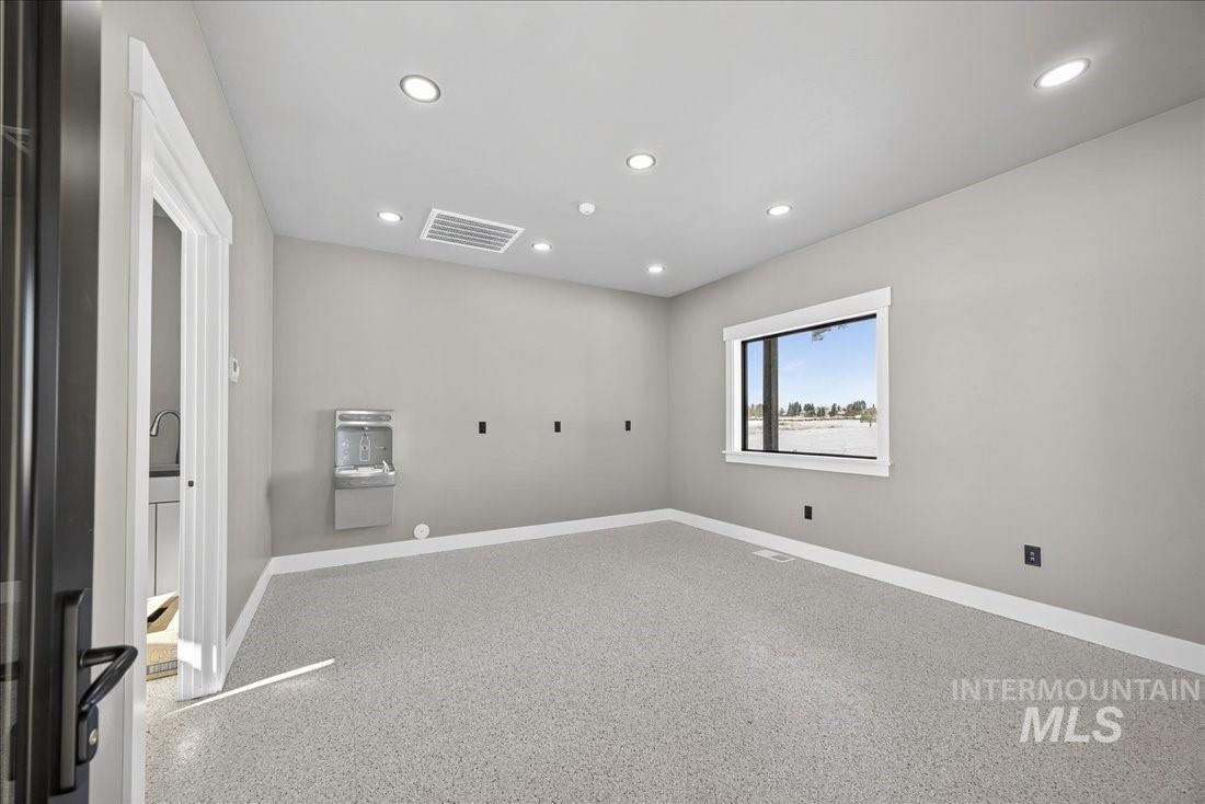39 Sunbridge Drive McCall, ID 83638 - Photo 8 of 10 Empty room featuring recessed lighting and dark speckled floor