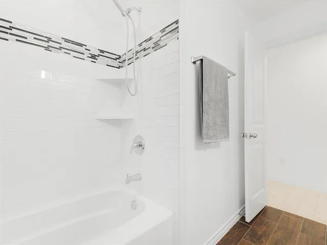 a bathroom with a bathtub and a shower