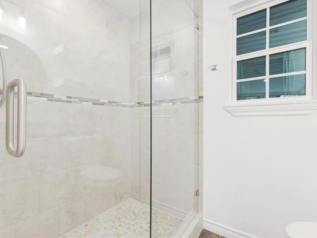 a bathroom with a window and shower