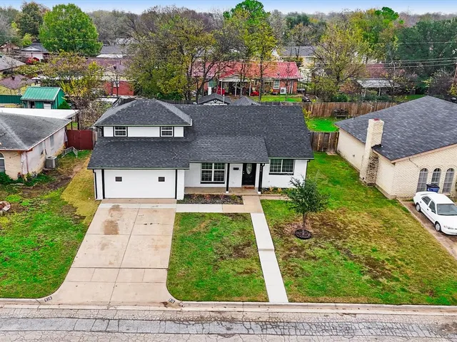a aerial view of a house with a yard